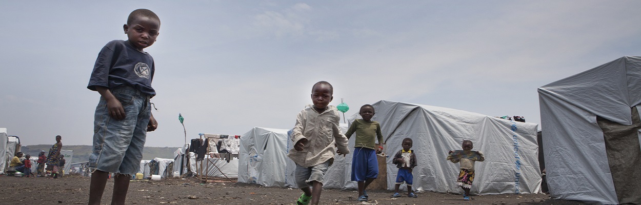 Eastern DRC humanitarian crisis Start Kanyarucinya children from congo stading in front of the tents