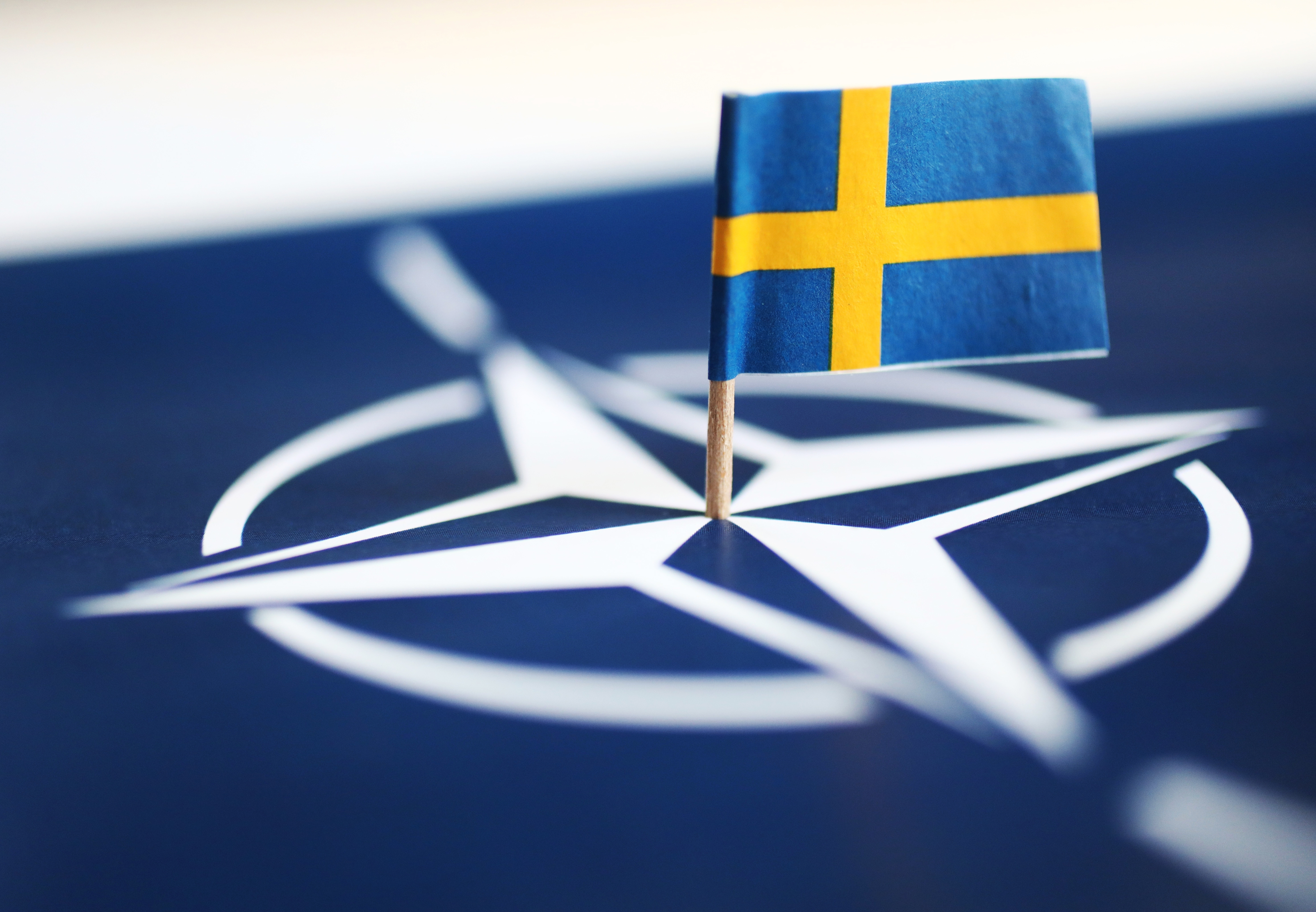 Sweden NATO neutrality Start MOTALA, SWEDEN- MAY 17, 2022: The Swedish flag and the NATO symbol.