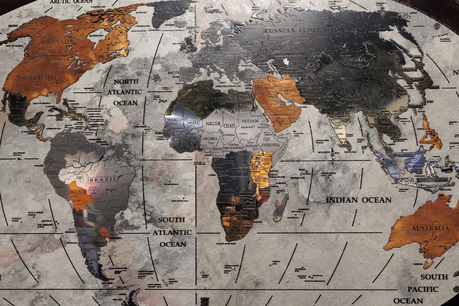 Geopolitics Of Africa. Start World geographic map made of metallic material with the African continent in the foreground.