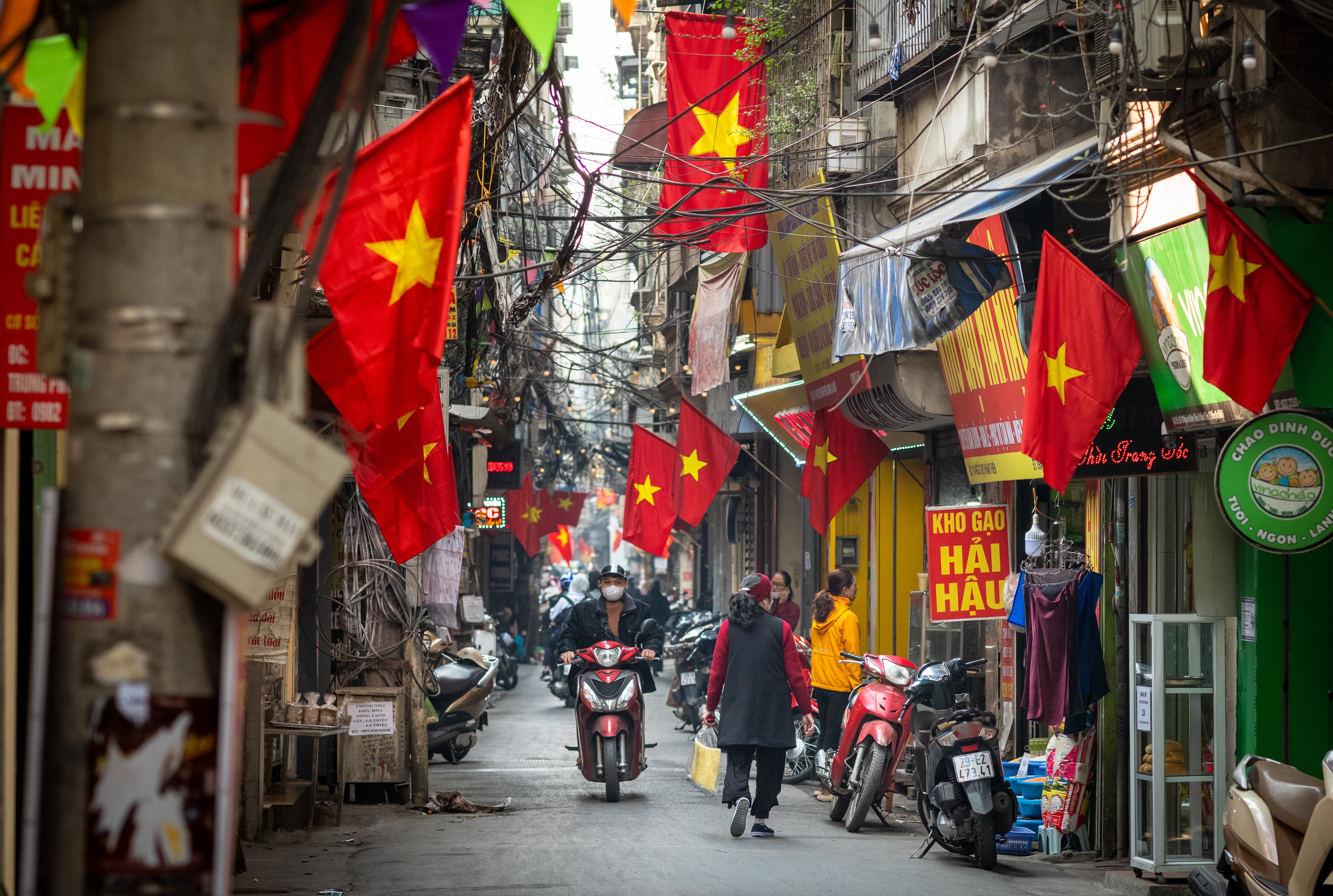 Vietnam EU Convergence Indo Pacific Order Hanoi Vietnam Jan 30 2023 People go about daily life under Vietnamese flags in a narrow residential alleyway called Kham Thien Market in Hanoi Vietnam