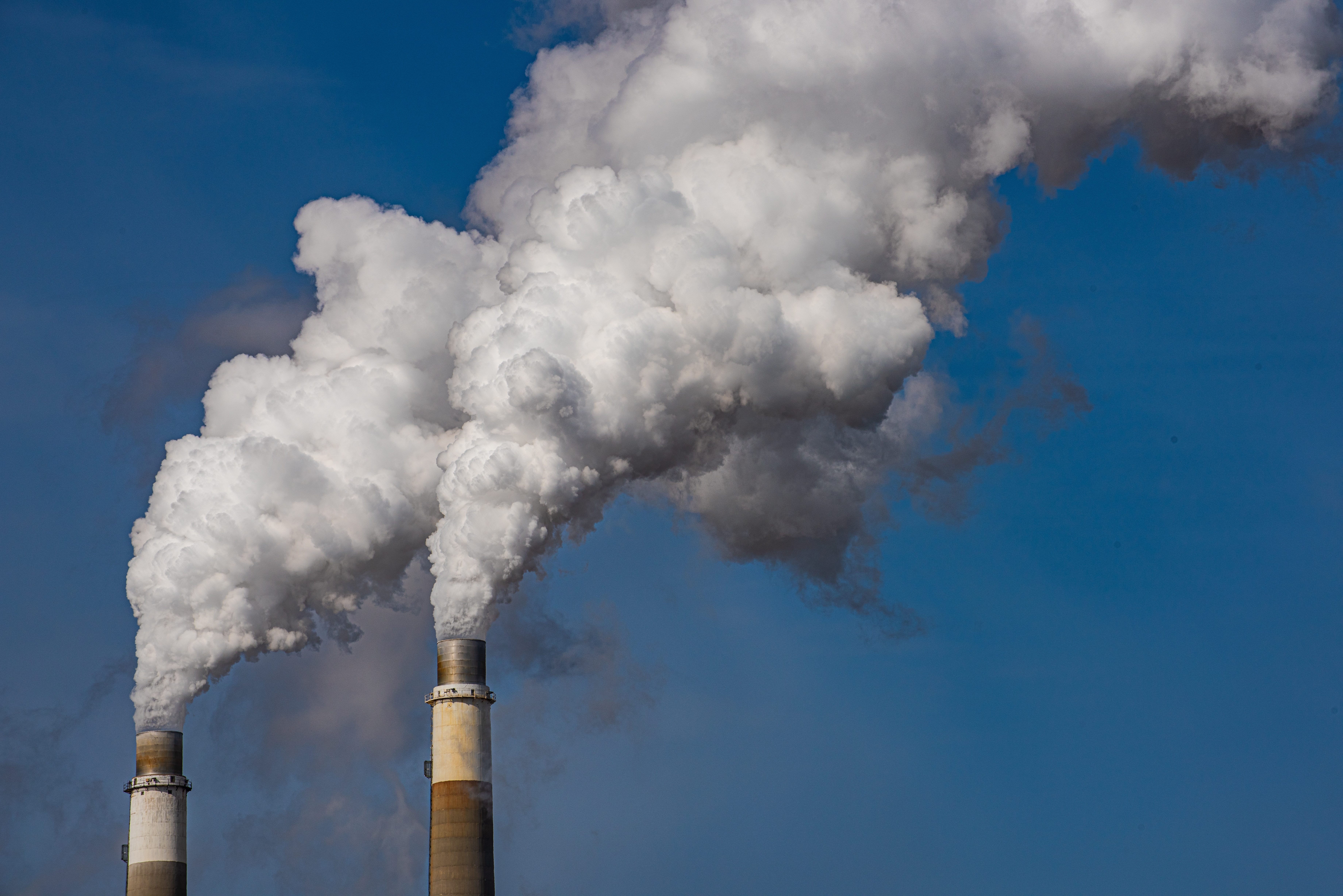 Climate crisis emissions threshold 2024 Start Exhaust stacks from coal fired power plant emitting waste products to atmosphere.