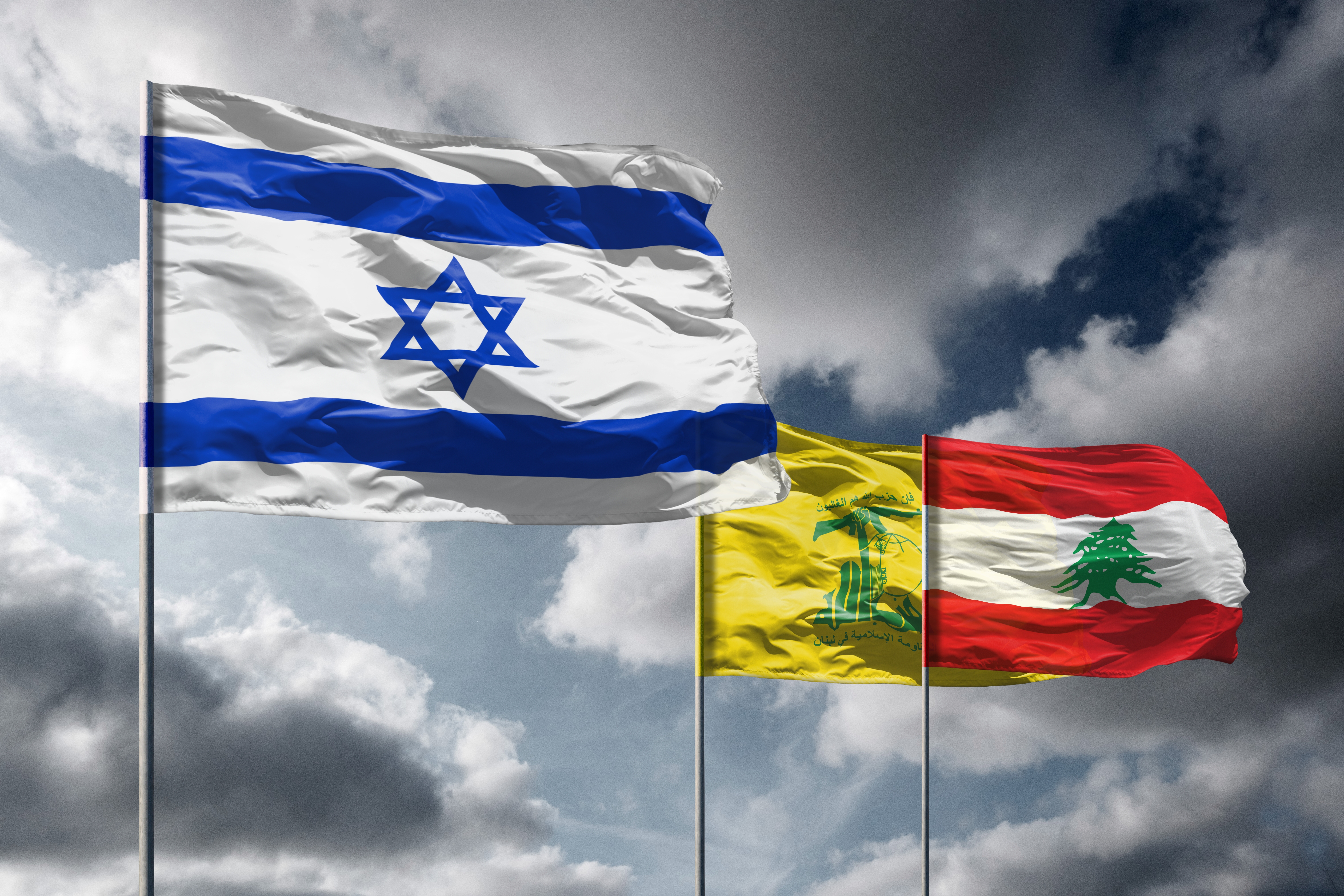 Israeli invasion Lebanon flags with Hezbollah and Lebanese banners