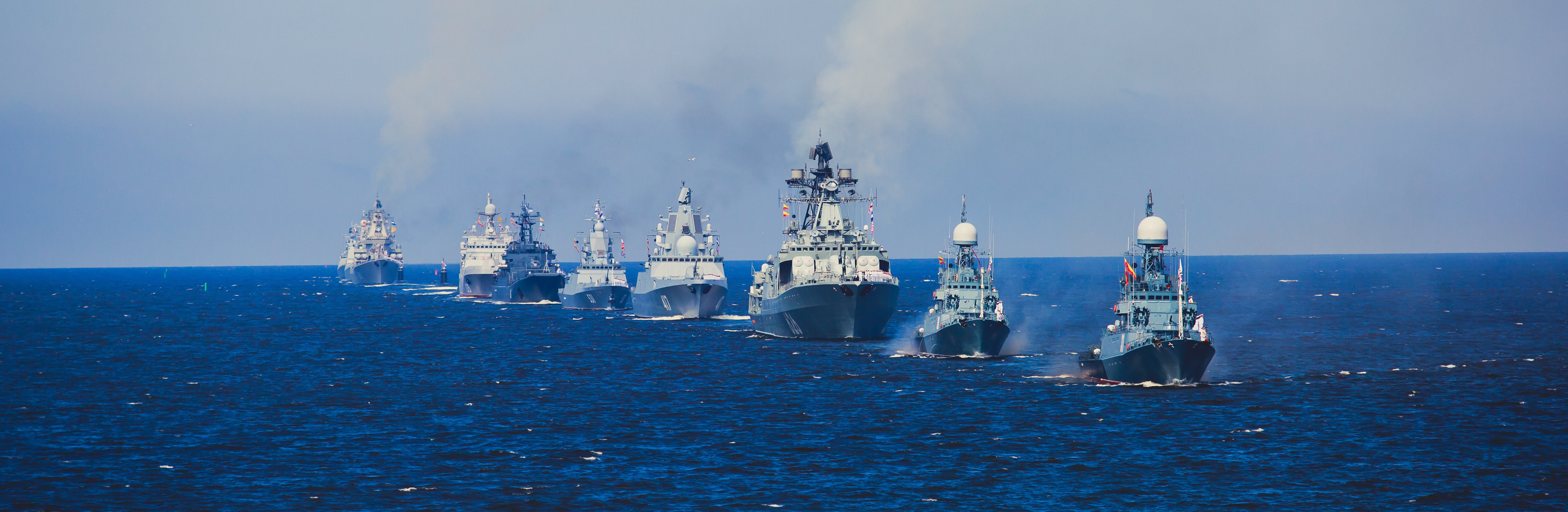 A line of Russian warships at sea representing NATO Baltic Sea Security challenges and evolving military strategies
