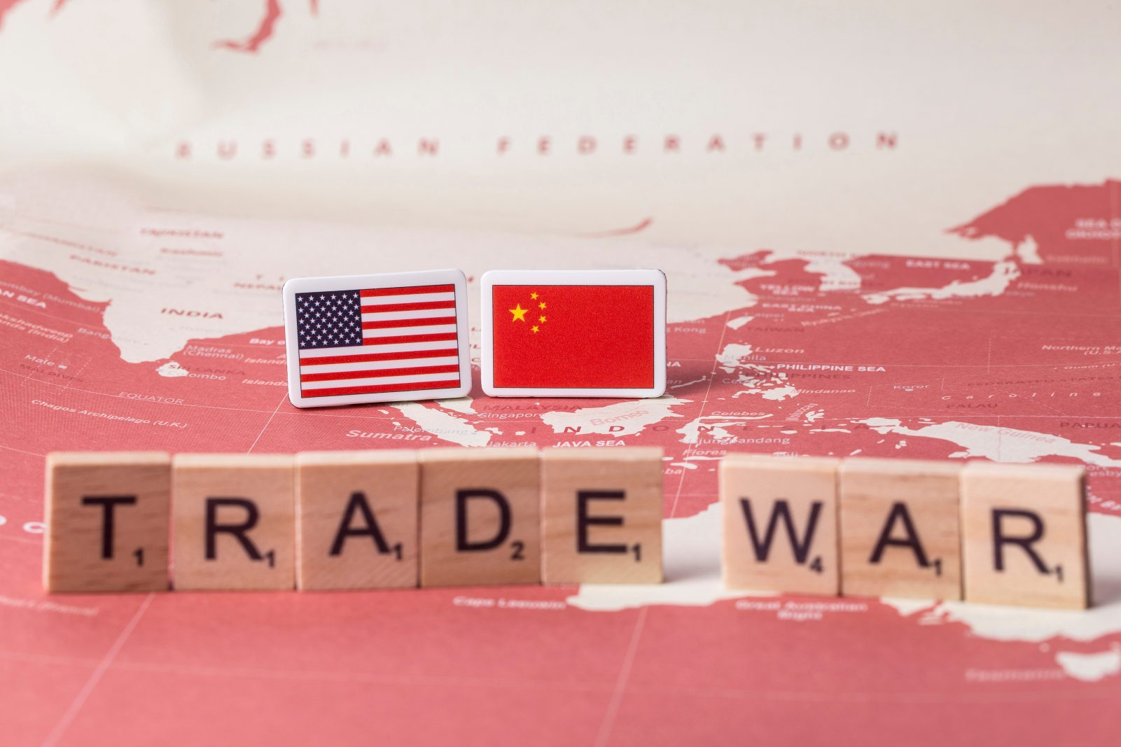 International trade war – Spice Road vs Silk Road, US, China, and Korea flags in Seoul studio, symbolic of escalating trade tensions