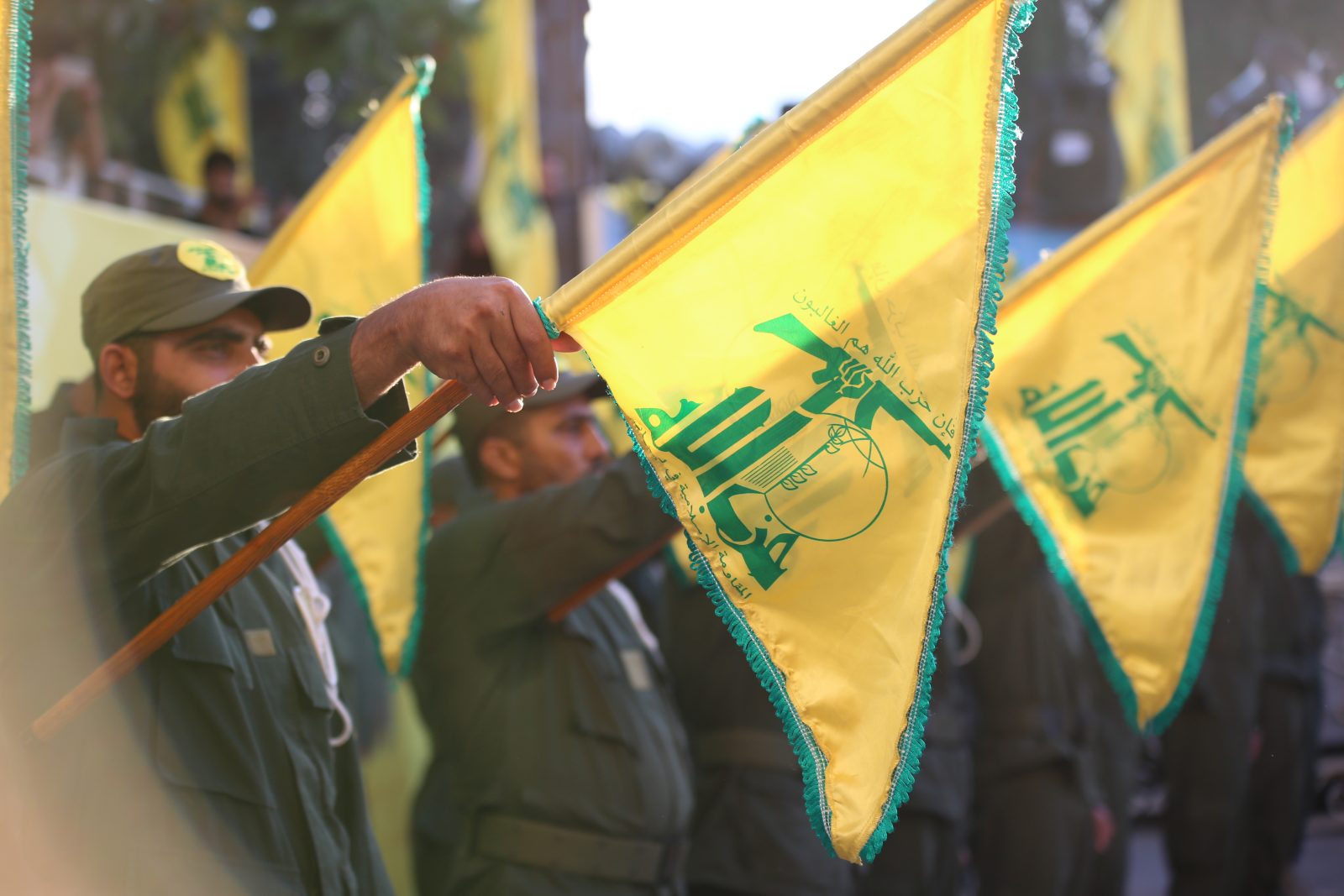 "Start Aitit,southern Lebanon Lebanon, Hezbollah future is uncertain and Hezbollah's flags carried on the shoulders of Islamic fighters during a military salute for the funeral of martyr."