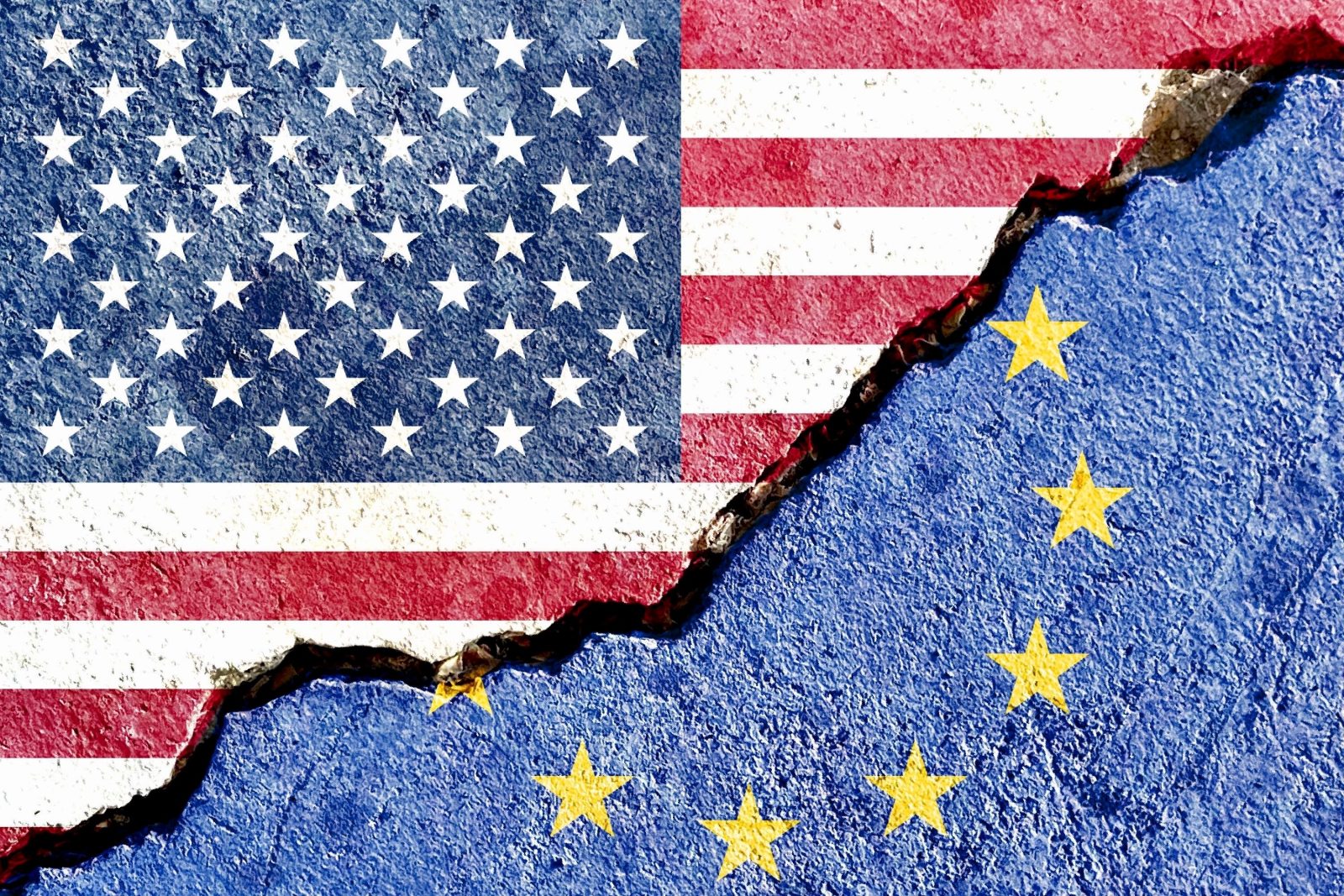 US and EU flags painted on cracked wall symbolizing political conflict and division