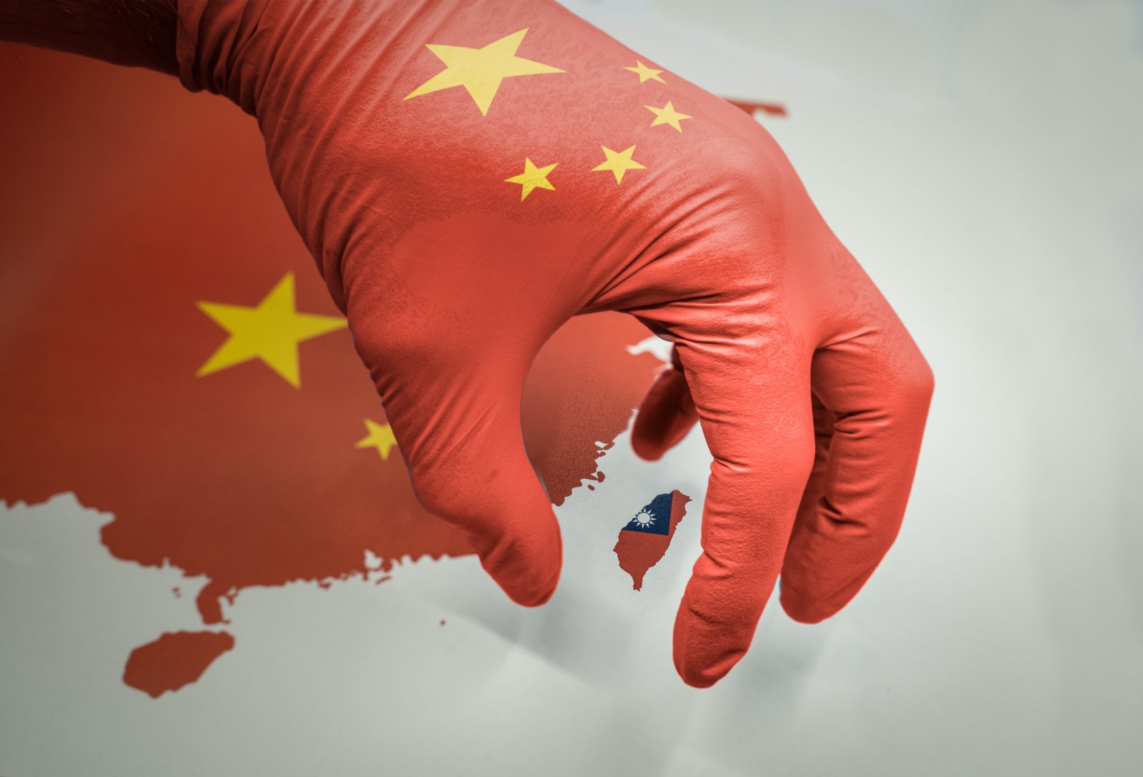 Forceful Taiwan reunification illustrated by hand grabbing Taiwan island on map