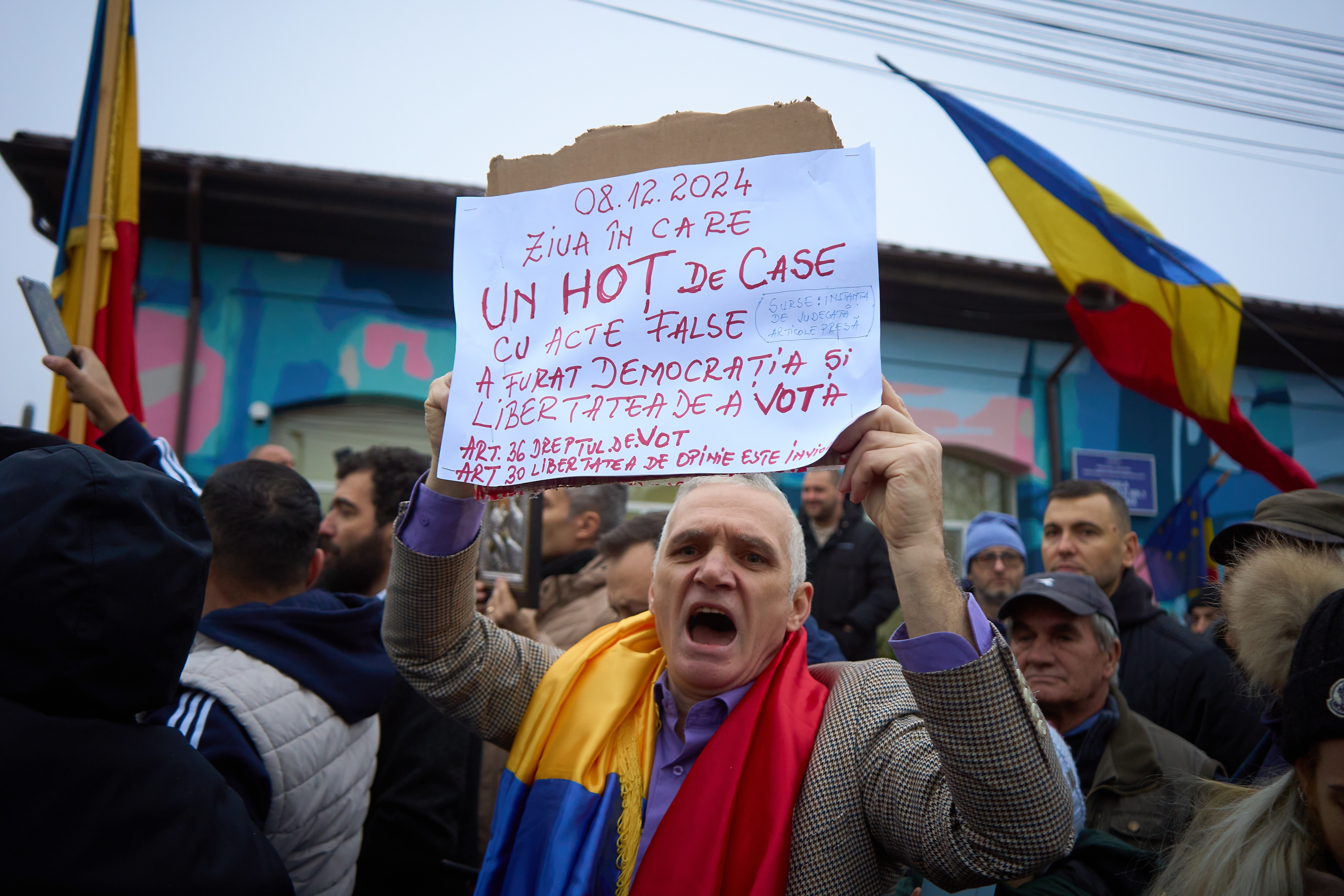 Romania election aftershock Mogosoaia Romania 8th Dec 2024 A man shouts as far right runoff candidate for presidency Calin Georgescu speaks to the press at a closed polling station after the elections were annulled