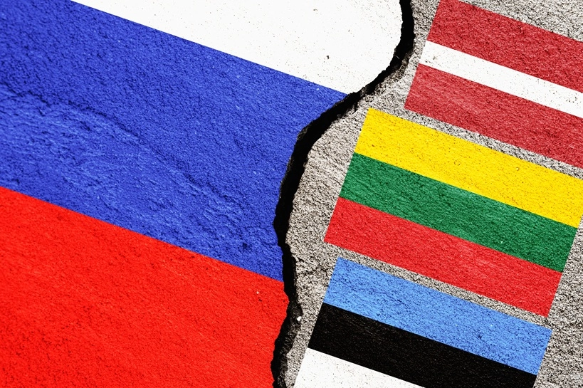 Russian and Baltic flags on cracked wall showing conflict in region
