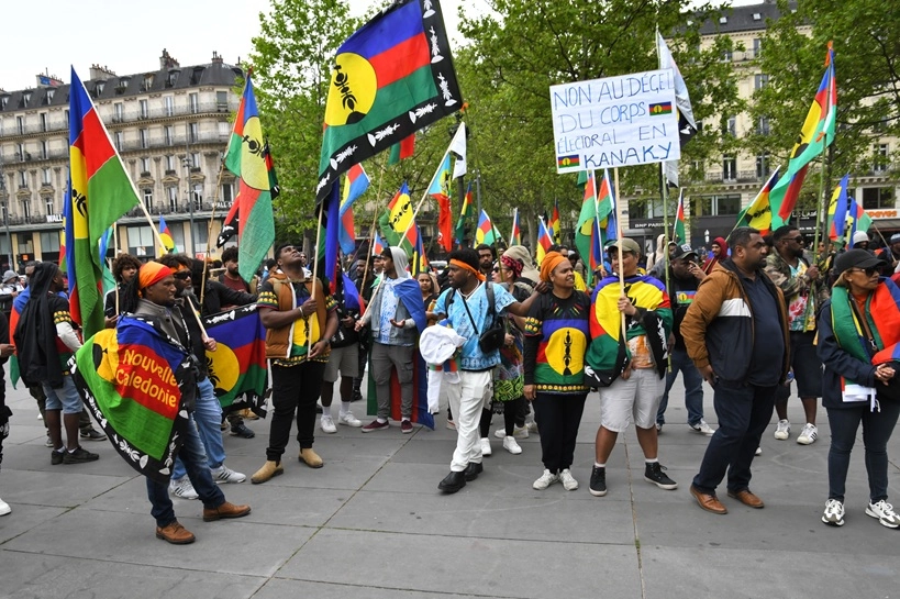New Caledonia statehood France shown during May Day protest in Paris with workers, students, and labor unions marching
