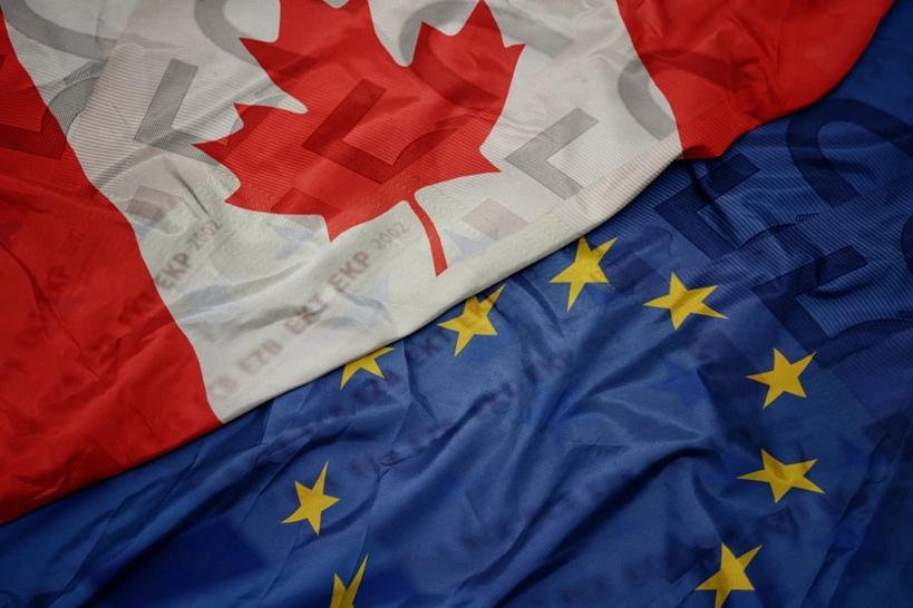 Europe Canada Transatlantic Partnership: Start waving colorful flag of european union and flag of canada on a euro money banknotes background