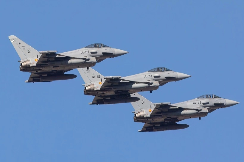MADRID, SPAIN - OCTOBER, 2023: 3 EF-2000 Eurofighter Typhoons (part of a group of 9) flying over Madrid as part of the Spain Day celebration. October 4, 2023, Madrid, Spain