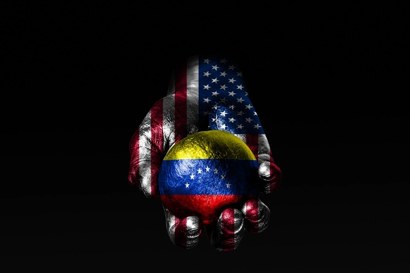 A hand with a drawn USA flag holds a ball with a drawn Venezuela flag, a sign of influence, pressure or conservation and protection. Horizontal frame