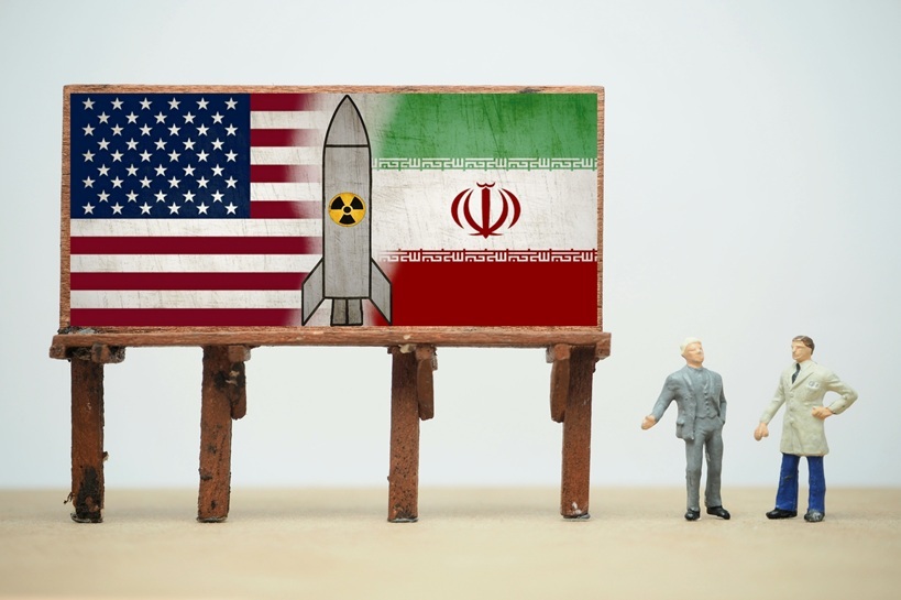 Mini toy of action figure with blurred background. Business financial photography concept design. Minifigure of politician character with United of America and IRAN country flag. Miniature people.