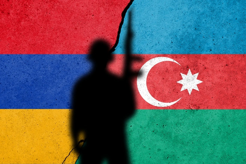 Armenia and Azerbaijan conflict in Nagorno Karabakh. Azerbaijan and Armenian flag on the cracked concrete wall with soldier. Armenian refugee