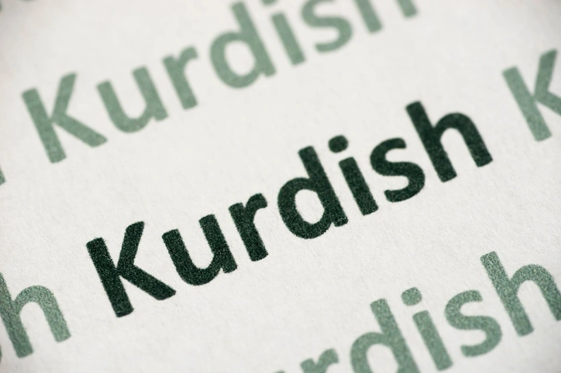 word Kurdish language printed on white paper macro