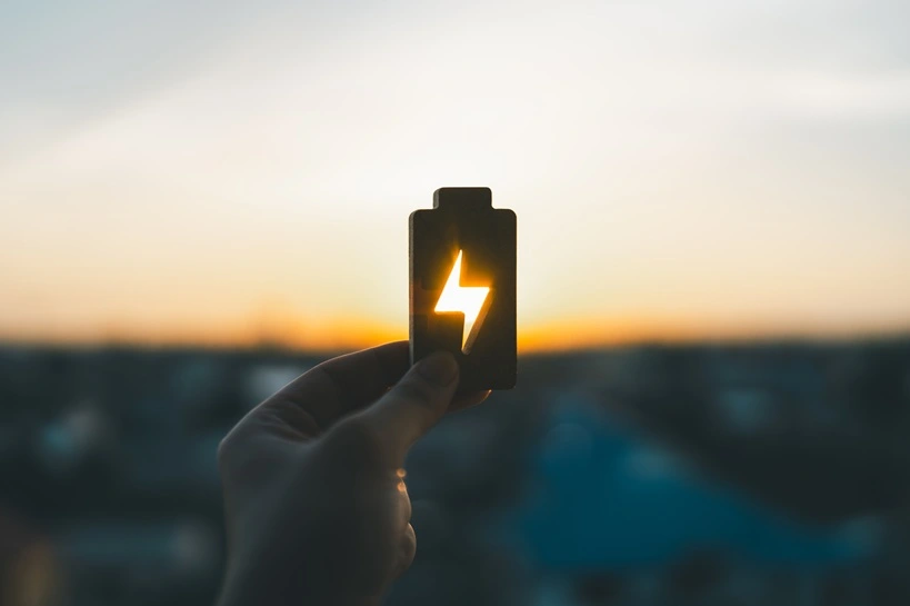 Technology battery high power electric energy with a connected charging cable. Battery to electric cars and mobile devices with clean electric, Green renewable energy battery storage future. Source: Shutterstock