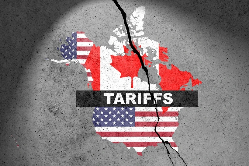 Canada and USA flags map painted on the concrete wall with word TARIFFS. Duty, trade, customs and tariffs war. Source: Shutterstock