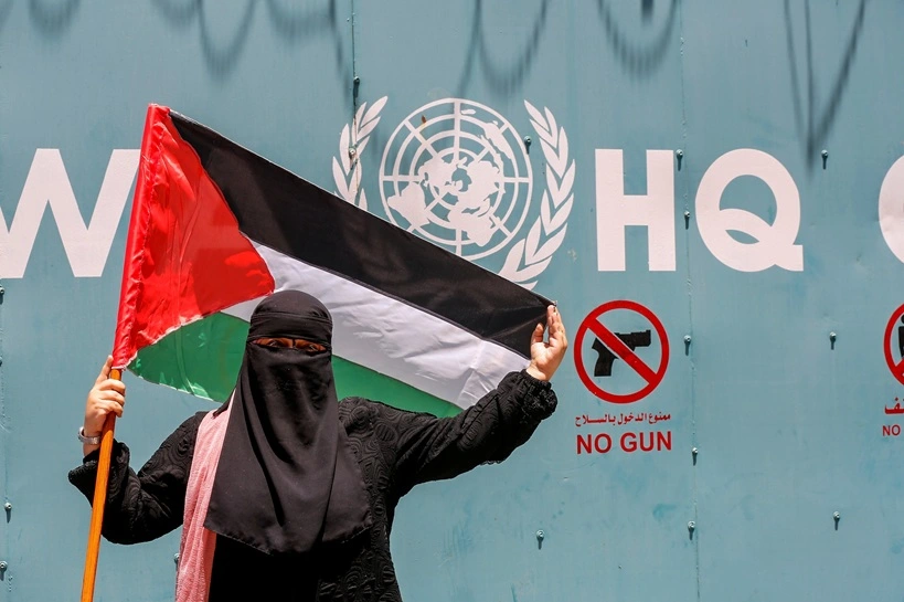 Palestinian refugees gather with national flags outside the United Nations Relief and Works Agency (UNRWA) in Gaza City on June 20, 2023, to protest cuts in aid. Source: Shutterstock